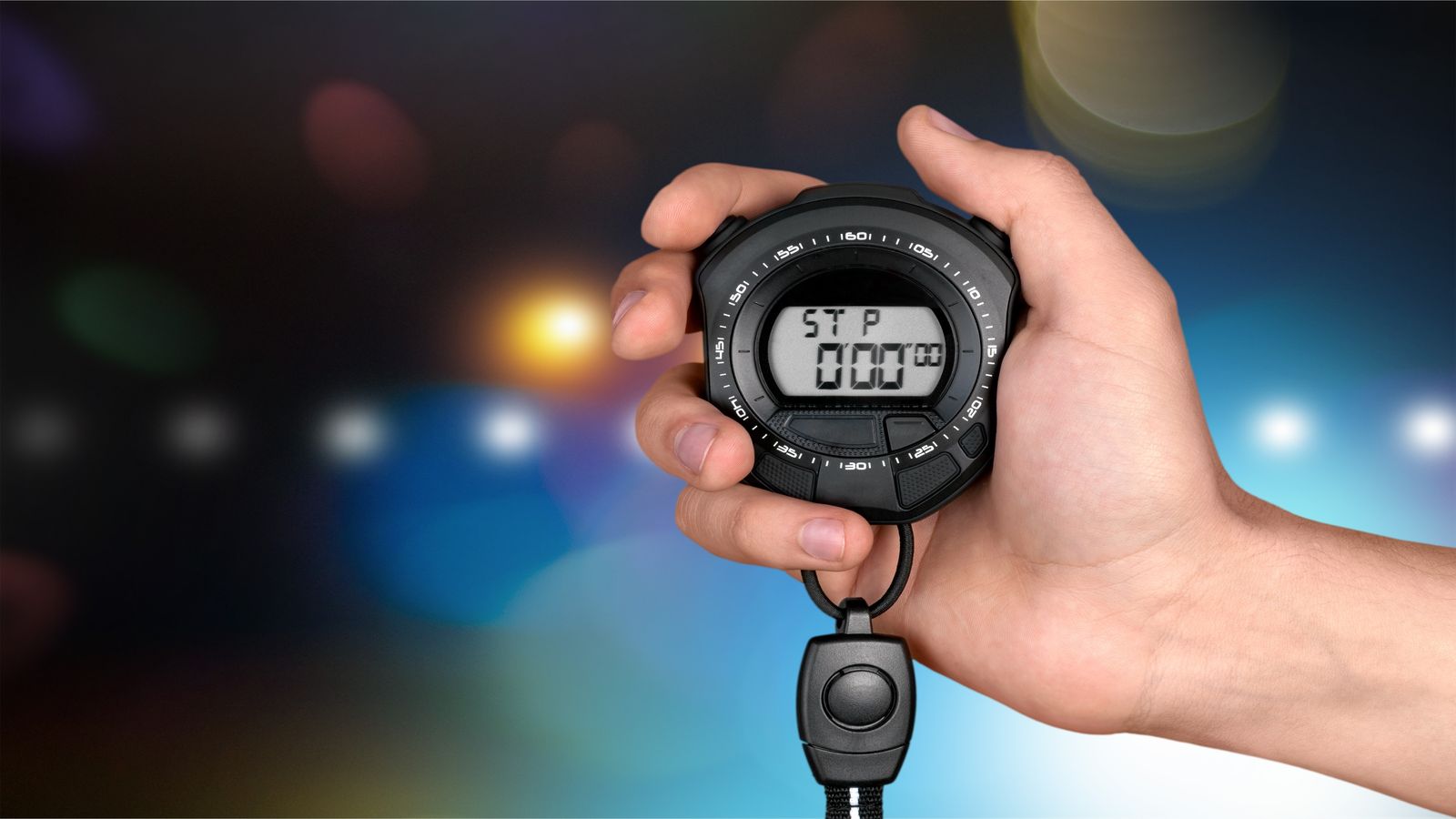 Stopwatch beside an open laptop with a terminal showing boot timing output