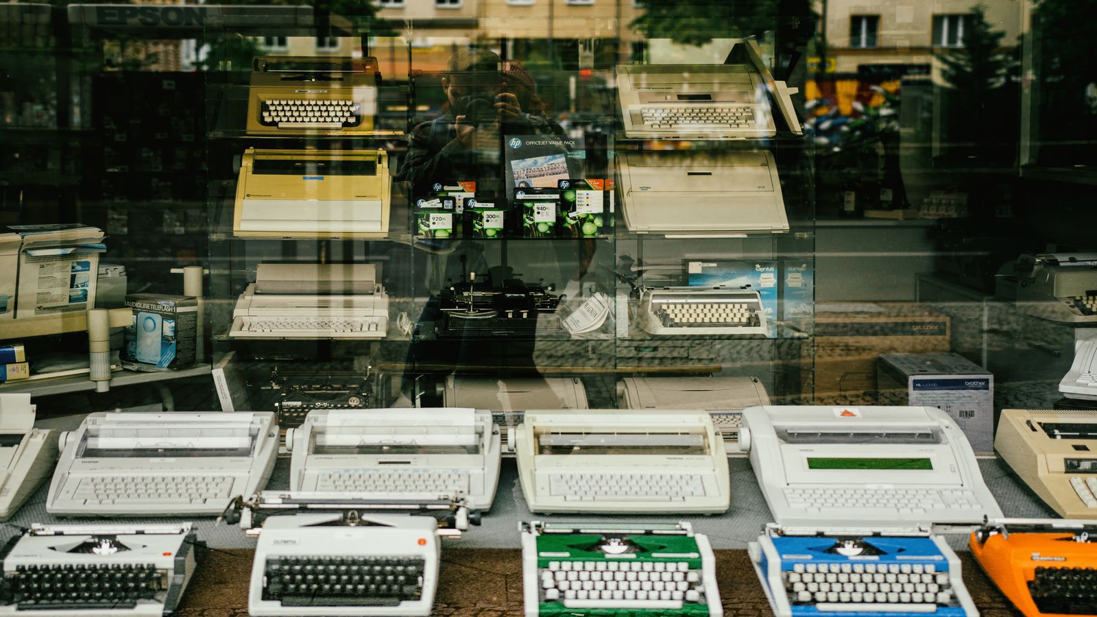Row of older laptops on a workbench with pass and fail labels beside each one