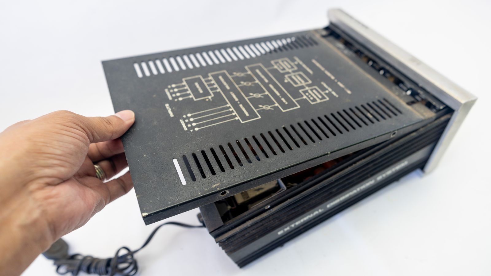 Laptop BIOS settings screen with a notepad and pen beside it